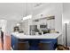 Modern kitchen with white cabinets and a blue breakfast bar at 809 Normandy Trace Rd, Tampa, FL 33602
