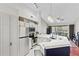 Modern kitchen with white cabinets and a blue breakfast bar at 809 Normandy Trace Rd, Tampa, FL 33602