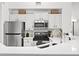 Bright kitchen featuring white cabinets, stainless steel appliances, and quartz countertops at 809 Normandy Trace Rd, Tampa, FL 33602