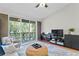 Spacious living room featuring a sectional sofa, a coffee table, and access to a balcony at 809 Normandy Trace Rd, Tampa, FL 33602