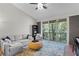 Relaxing living room with sectional sofa and sliding glass doors leading to a balcony at 809 Normandy Trace Rd, Tampa, FL 33602