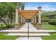 Brick pathway leading to community features under a pergola at 809 Normandy Trace Rd, Tampa, FL 33602