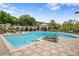 Community pool with surrounding lounge chairs at 809 Normandy Trace Rd, Tampa, FL 33602