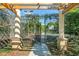 View of a tennis court through a partially opened gate at 809 Normandy Trace Rd, Tampa, FL 33602