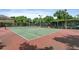 Well-maintained tennis court with red and green surface at 809 Normandy Trace Rd, Tampa, FL 33602