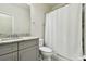 Bathroom with gray vanity, granite countertop, and bathtub at 8126 Muddy Pines Pl, Tampa, FL 33635