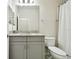Bathroom with gray vanity, granite countertop, and bathtub at 8126 Muddy Pines Pl, Tampa, FL 33635