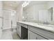 Bathroom with shower, double vanity, and granite countertop at 8126 Muddy Pines Pl, Tampa, FL 33635