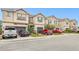 Tan townhouses with gray garage doors and blue shutters at 8126 Muddy Pines Pl, Tampa, FL 33635