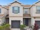 Two-story townhome with gray siding and garage at 8126 Muddy Pines Pl, Tampa, FL 33635