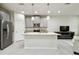 Modern kitchen with gray cabinets, granite counters, and island at 8126 Muddy Pines Pl, Tampa, FL 33635