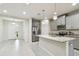 Modern kitchen with gray cabinets, granite counters, and island at 8126 Muddy Pines Pl, Tampa, FL 33635