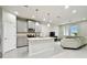 Modern kitchen with gray cabinets, granite counters, and island at 8126 Muddy Pines Pl, Tampa, FL 33635