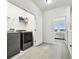 Upstairs laundry room with washer and dryer and extra storage at 8126 Muddy Pines Pl, Tampa, FL 33635