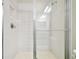 Large walk-in shower with glass enclosure and white tile at 8126 Muddy Pines Pl, Tampa, FL 33635