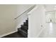 Modern dark wood staircase leading to the second floor at 8126 Muddy Pines Pl, Tampa, FL 33635