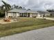 Well-maintained house with a gray roof and landscaped lawn at 943 Columbia Ter, Port Charlotte, FL 33948