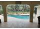 View of the lovely pool with a brick trim surrounded by lush greenery at 943 Columbia Ter, Port Charlotte, FL 33948