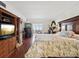 Main bedroom with hardwood floors, access to balcony, and bay views at 5200 Brittany S Dr # 1204, St Petersburg, FL 33715