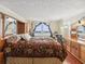 Bedroom with a queen bed, water views, and hardwood floors at 5200 Brittany S Dr # 1204, St Petersburg, FL 33715