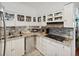 Well-equipped kitchen featuring granite counters and white cabinetry at 5200 Brittany S Dr # 1204, St Petersburg, FL 33715