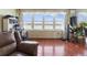 Living room features hardwood floors, bay windows and city views at 5200 Brittany S Dr # 1204, St Petersburg, FL 33715