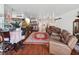 Sunlit living room with hardwood floors and a view to dining area at 5200 Brittany S Dr # 1204, St Petersburg, FL 33715