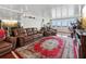 Spacious living room with leather furniture, large windows, and hardwood floors at 5200 Brittany S Dr # 1204, St Petersburg, FL 33715