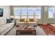 Living room with hardwood floors, water views and comfy seating at 5200 Brittany S Dr # 1204, St Petersburg, FL 33715