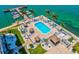 Relaxing waterfront pool area with ample lounge chairs and tiki huts at 5200 Brittany S Dr # 1204, St Petersburg, FL 33715