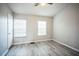 Well-lit bedroom with two windows and wood-look flooring at 10157 Bessemer Pond Ct, Riverview, FL 33578