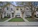 Two-story townhome with gray exterior, two-car driveway, and landscaping at 10157 Bessemer Pond Ct, Riverview, FL 33578