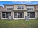 Rear view of townhome with screened patios and AC units at 10157 Bessemer Pond Ct, Riverview, FL 33578