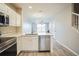Modern kitchen with white cabinets, island and stainless steel appliances at 10157 Bessemer Pond Ct, Riverview, FL 33578