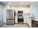 Modern kitchen with stainless steel appliances and white cabinets at 10157 Bessemer Pond Ct, Riverview, FL 33578