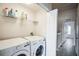 Convenient laundry room with washer, dryer, and shelving at 10157 Bessemer Pond Ct, Riverview, FL 33578