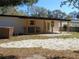Large backyard with covered patio and outdoor kitchen at 10322 N Oakleaf Ave, Tampa, FL 33612
