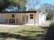 Outdoor patio with built-in kitchen and covered seating area at 10322 N Oakleaf Ave, Tampa, FL 33612