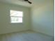 Well-lit bedroom with hardwood floors and window at 10322 N Oakleaf Ave, Tampa, FL 33612