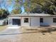 Newly renovated home with a white brick exterior and landscaping at 10322 N Oakleaf Ave, Tampa, FL 33612