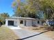 Newly renovated home with attached garage and driveway at 10322 N Oakleaf Ave, Tampa, FL 33612