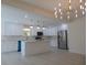 Open concept kitchen with island, white cabinets and high end finishes at 10322 N Oakleaf Ave, Tampa, FL 33612