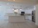 Open concept kitchen with island, white cabinets and high end finishes at 10322 N Oakleaf Ave, Tampa, FL 33612