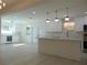 Open concept kitchen with island, white cabinets and high end finishes at 10322 N Oakleaf Ave, Tampa, FL 33612