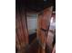 Small closet with open shelving and wooden door at 13225 2Nd E St, Madeira Beach, FL 33708