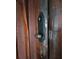 Close up of a dark brown wooden door with black hardware at 13225 2Nd E St, Madeira Beach, FL 33708