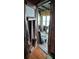 Rustic wood door opens to a sunlit interior porch at 13225 2Nd E St, Madeira Beach, FL 33708