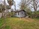 Rear view of a small gray house with a clothesline at 13225 2Nd E St, Madeira Beach, FL 33708