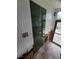 Green glass-door closet with tiled floor at 13225 2Nd E St, Madeira Beach, FL 33708