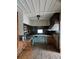 Rustic kitchen featuring light teal cabinets and wood flooring at 13225 2Nd E St, Madeira Beach, FL 33708